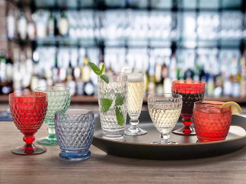 Boston glasses on a tray on a wooden table in the colours red, blue, green, white