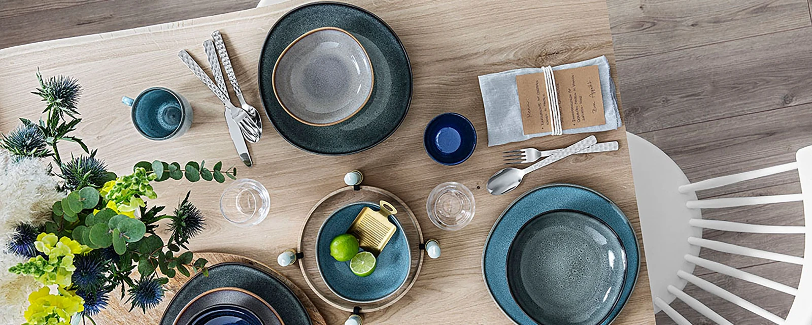 A wooden table with Lave plates from Villeroy & Boch on it.