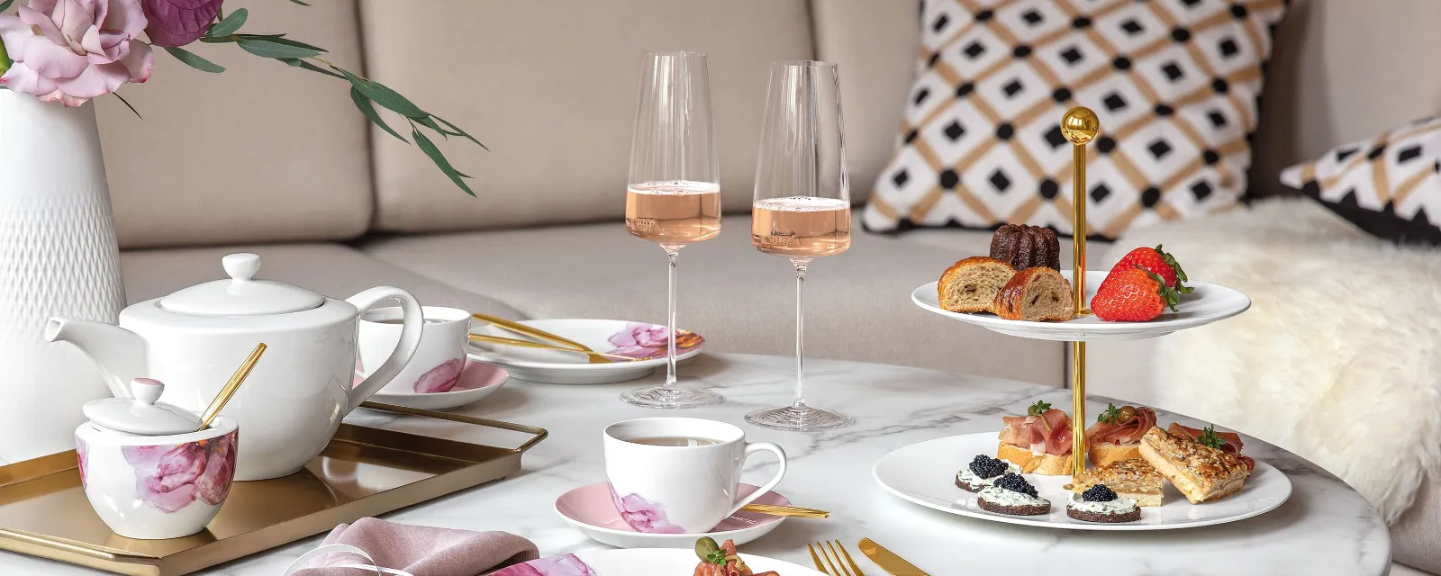 Elegant afternoon tea setting with snacks and rosé wine on a marble table, served on Villeroy & Boch Rose Garden crockery.