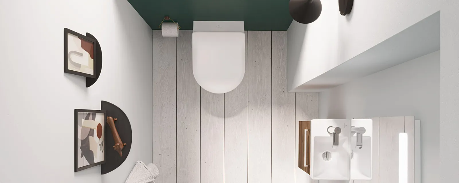 Bovenaanzicht van een badkamer met toilet en wastafel met spiegel uit de Avento collectie Bovenaanzicht van een kleine badkamer met aan de muur gemonteerde wastafel, spiegel, toilet en moderne inrichting met abstracte kunst. De ruimte heeft een witte vloer, witte muren en een houten deur.