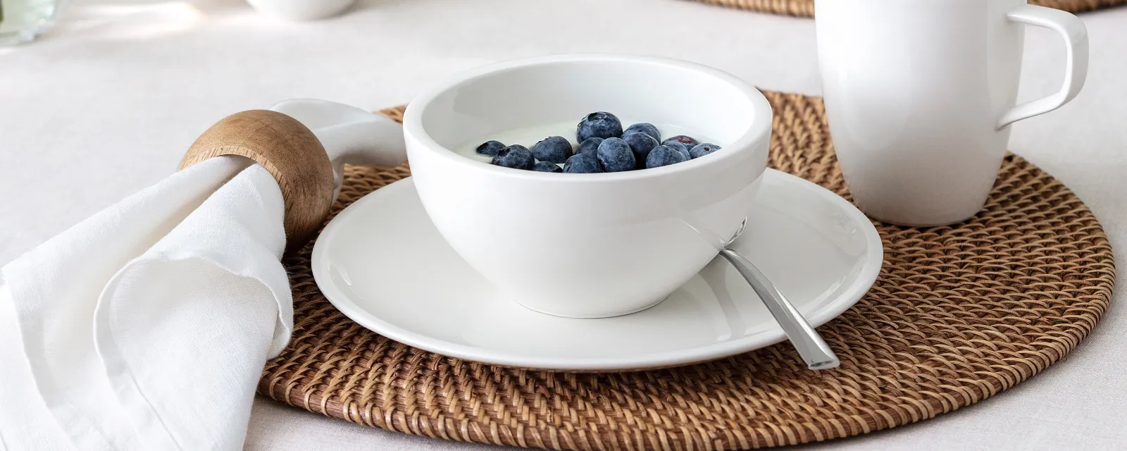 Breakfast table with artesano bowl with yogurt and blueberries