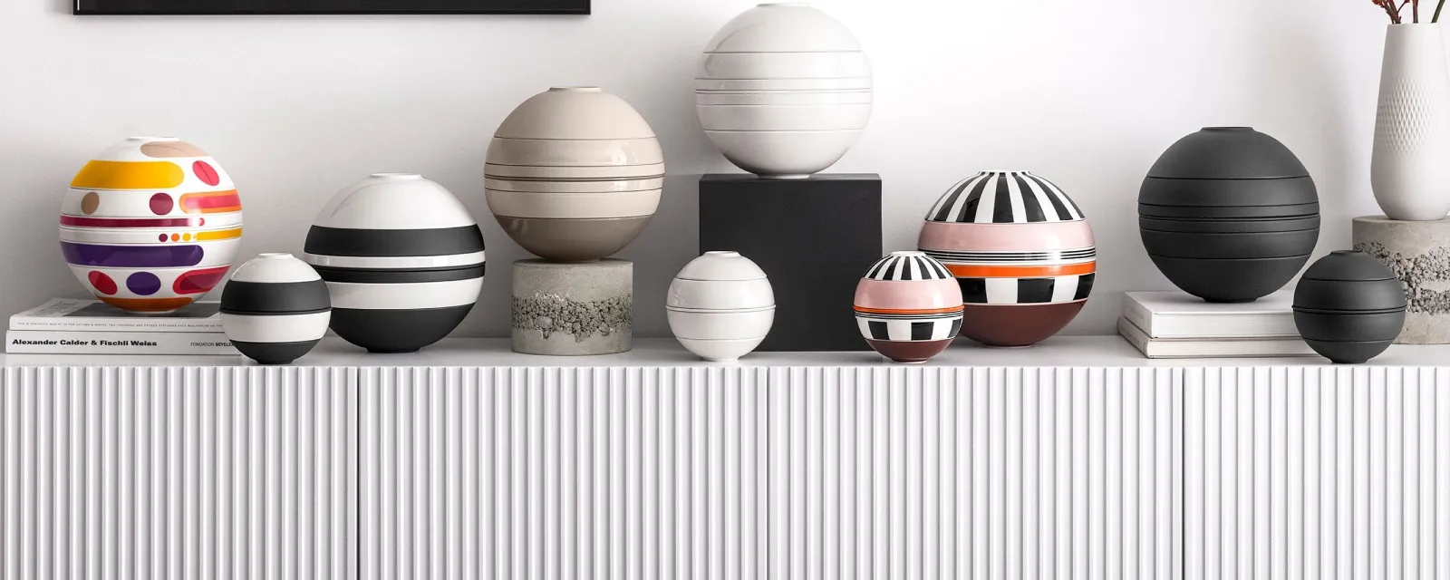 La Boule and La Petite Boule together on a sideboard la boule and la petite boule products shown in all the available color options on a white sideboard
