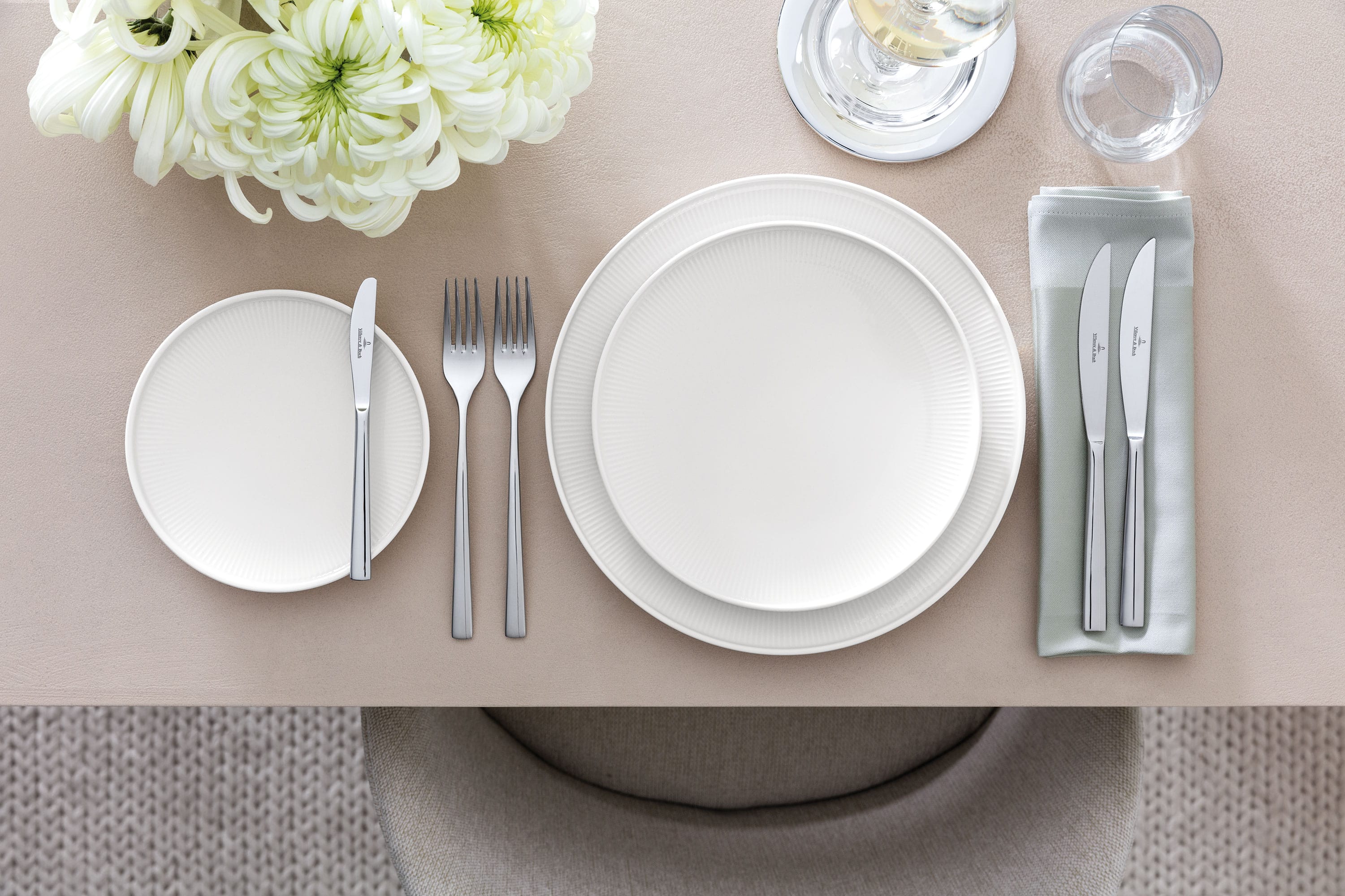 A set table with Afina plates from a sideways angle to see the floating effect of the plates.