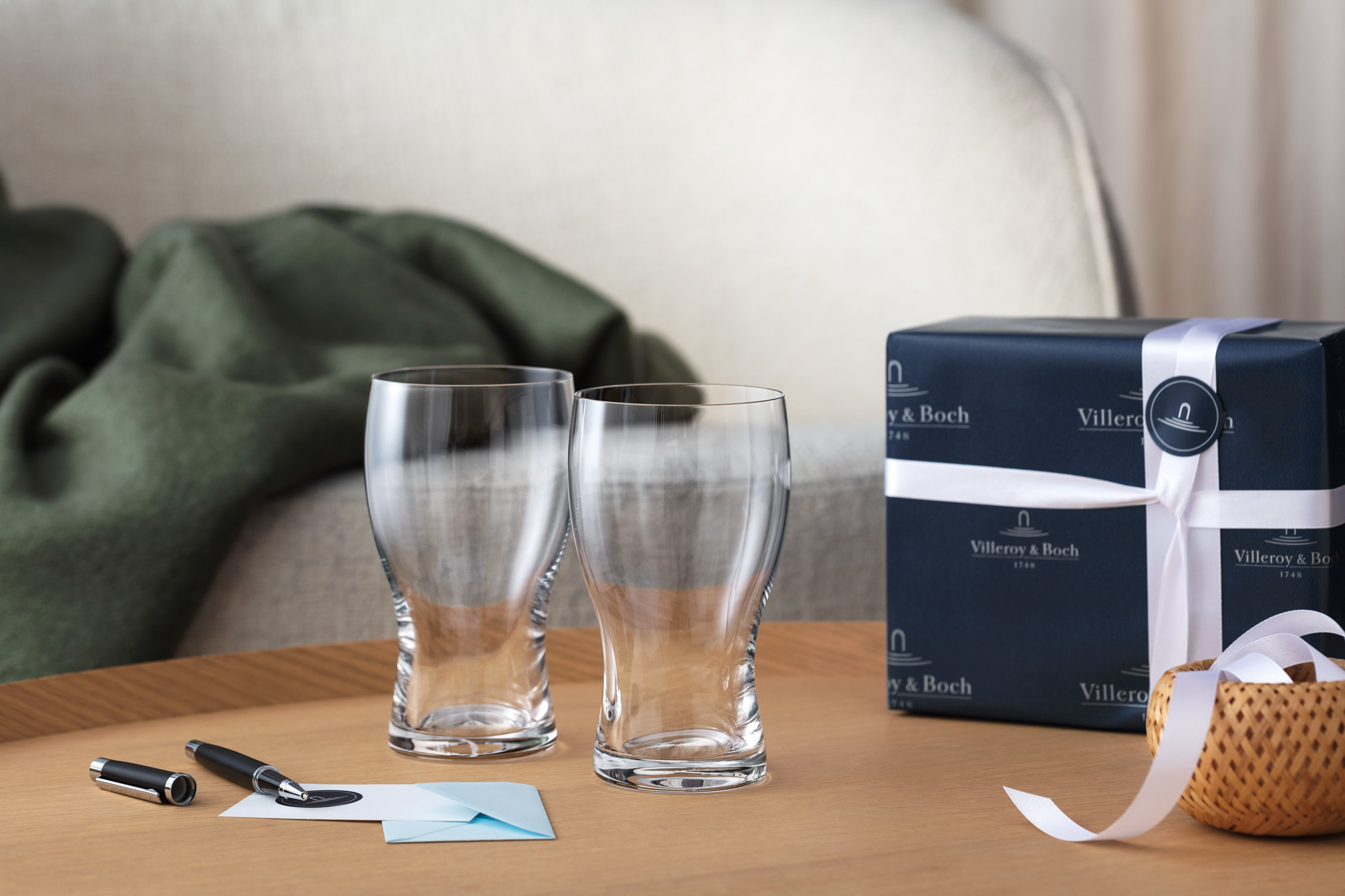 Two Purismo beer glasses from Villeroy & Boch as a gift with card and fountain pen and gift box in the background