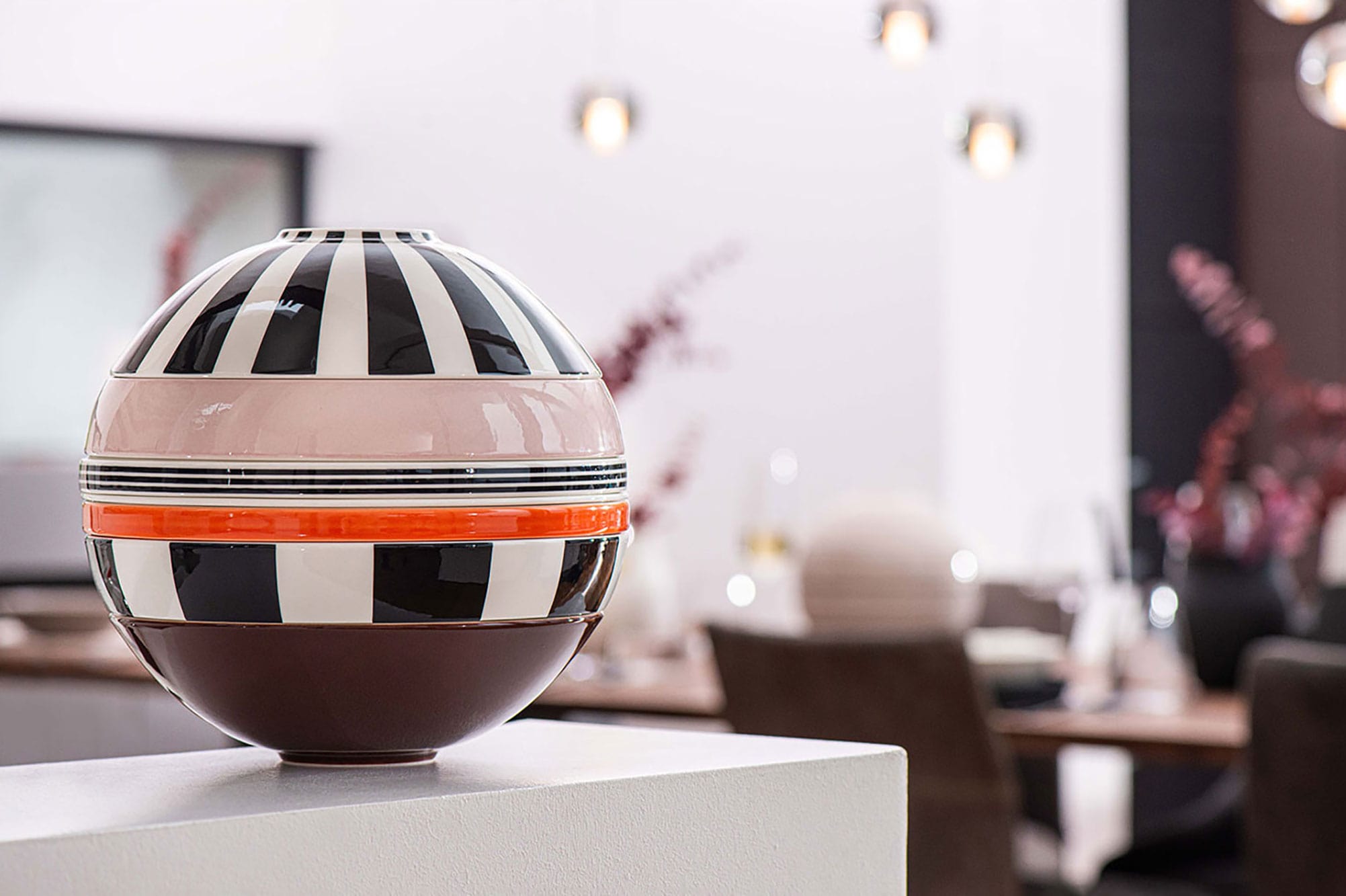 There is a striped La Boule Memphis from Villeroy & Boch on a table in the dining room.